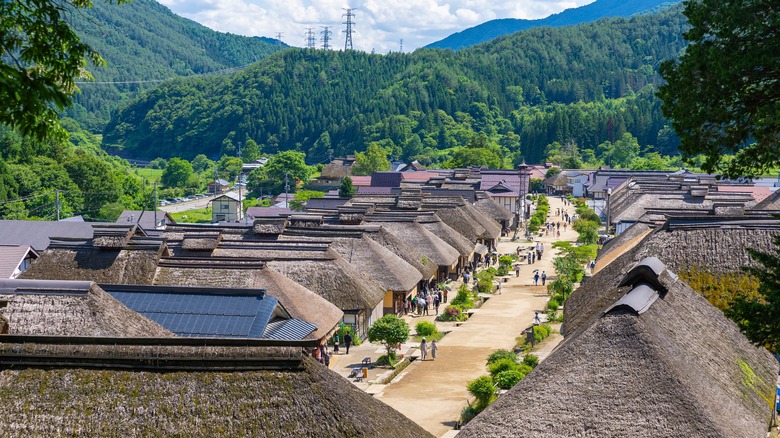 Main street in Ouchi-juku lined with Edo-era houses with thatched roofs