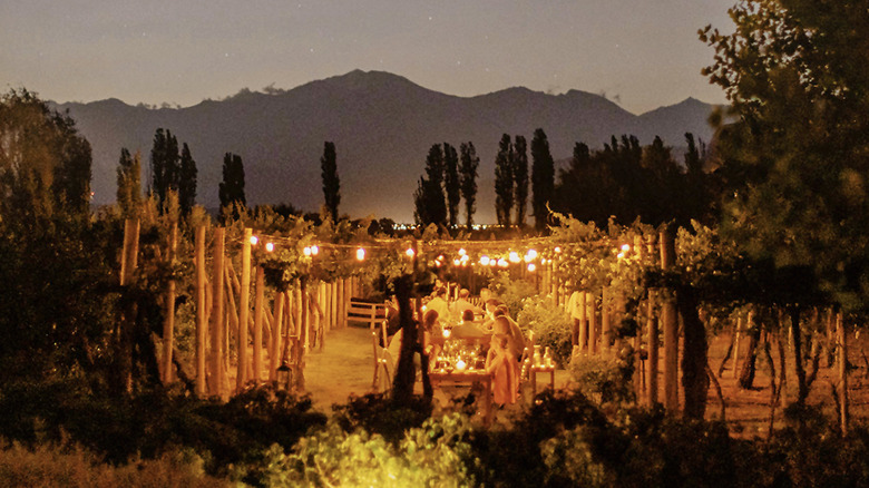 outdoor tables under a canopy in the twilight