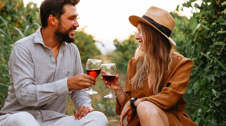 couple drinking wine in vineyard