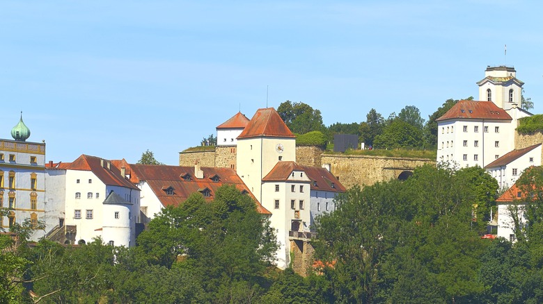 Aerial view of a large white castle with a red roof