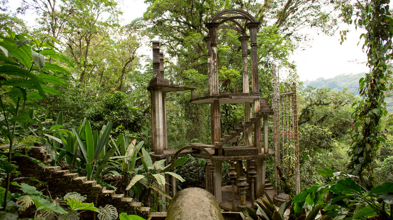 Surreal structures surrounded by jungle foliage
