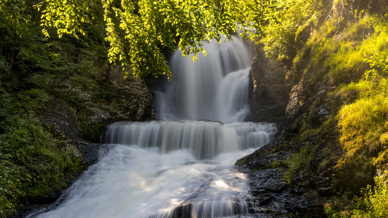 a large waterfalls surrounded by rocks and trees