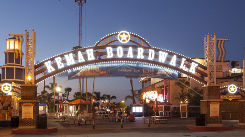 The Kemah Boardwalk entrance arch illuminated at night.