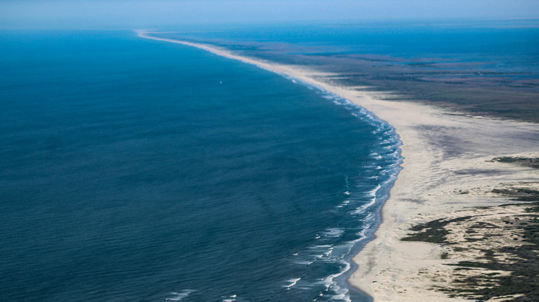 a long sandy beach on a remote island