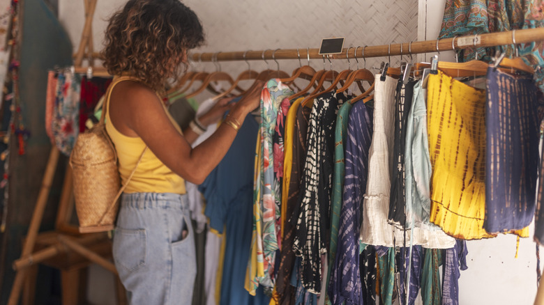 Woman looking through clothes rack