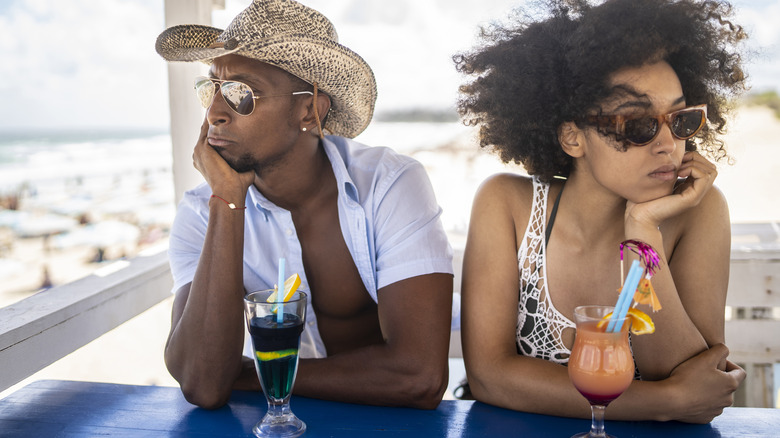 Upset couple at a beach bar