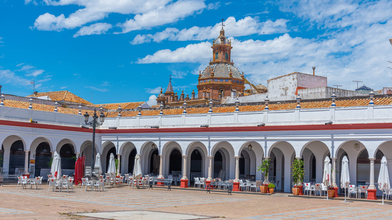 White arches and cafe tables in the market square in Carmona