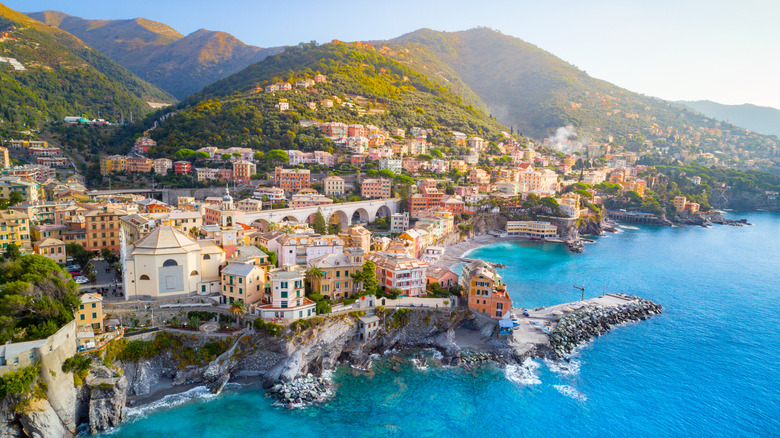 The village of Bogliasco on a small peninsula with towering green hills behind it