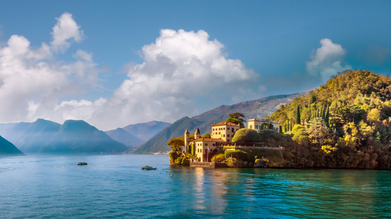 building on lake with mountains