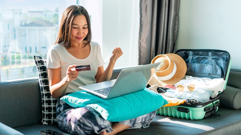 woman booking hotel on laptop