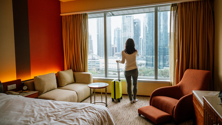 woman near hotel room window