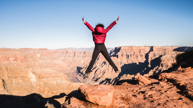 Woman jumping at grand canyon