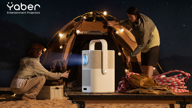 Campers setting up near the Yaber T2 Series Projector