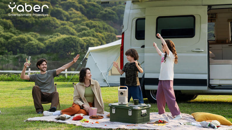 RV family dancing around the Yaber T2 Series Projector