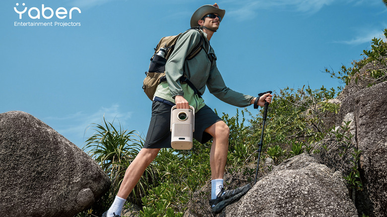 Hiker carrying the Yaber T2 Series Projector