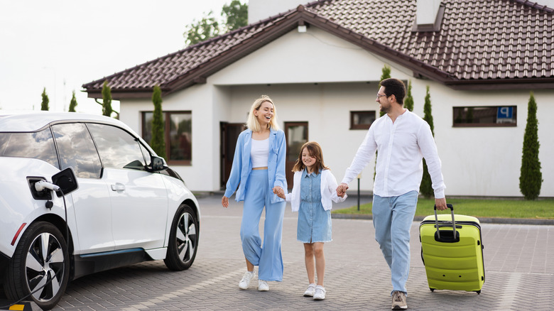 happy family with suitcases leaving vacation rental