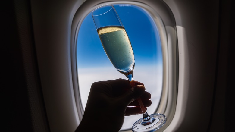 Champagne in front of an airplane window