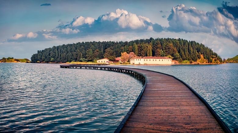 wooden bridge leading to island monastery