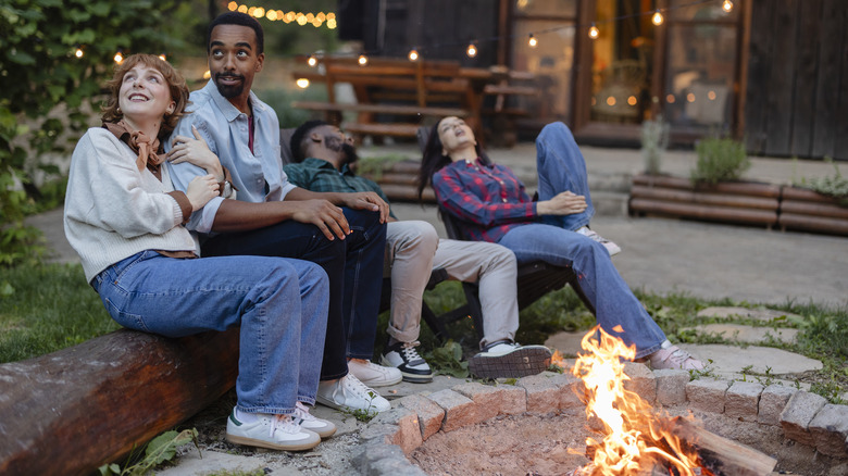 Family relaxing outside cabin