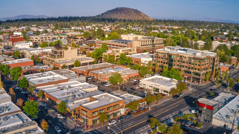 Aerial view of downtown Bend, Oregon, with mountains in the background