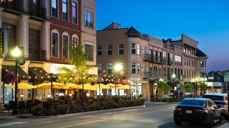 evening view of a downtown street with a sidewalk cafe and charming buildings in Carmel, Indiana