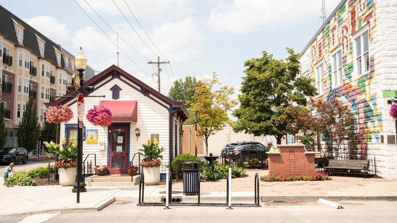 clean street in Carmel, Indiana with trees and a mural on a building