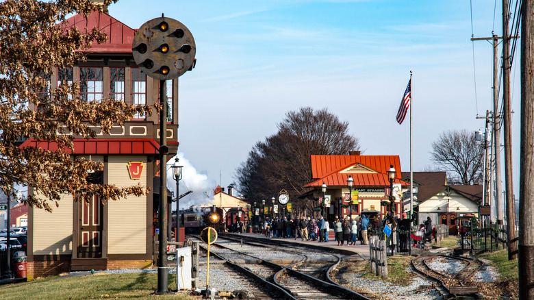 Crowds of people stand on the platform at East Strasburg Station in Pennsylvania.
