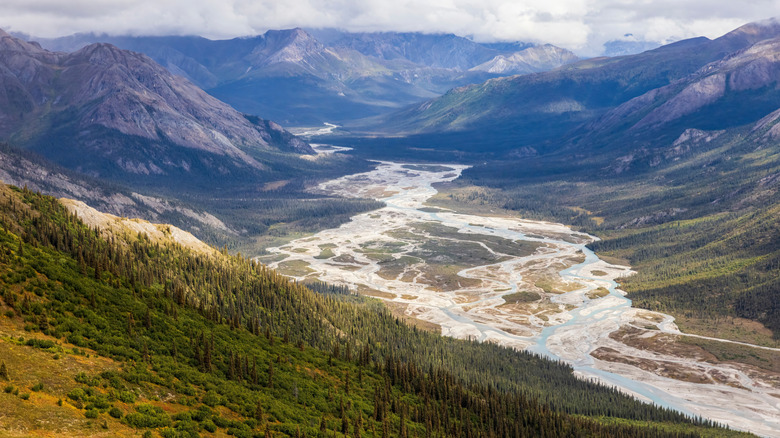 mountains with river running through it