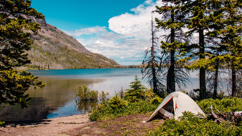 A tent alongside a lake at Glacier National Park.