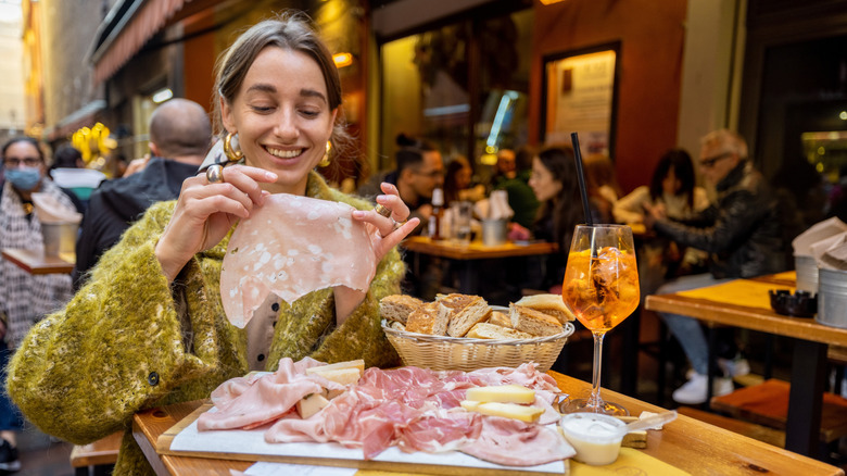 Woman eating antipasti in Italy