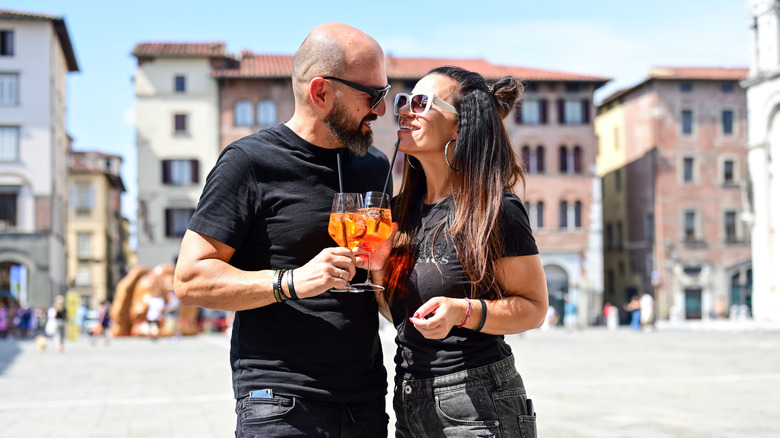 Couple drinking Aperol Spritz in Italy