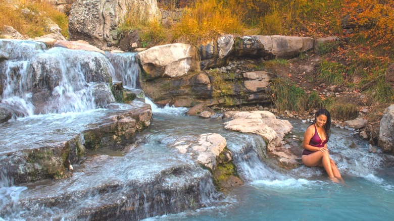 Woman sitting in hot spring