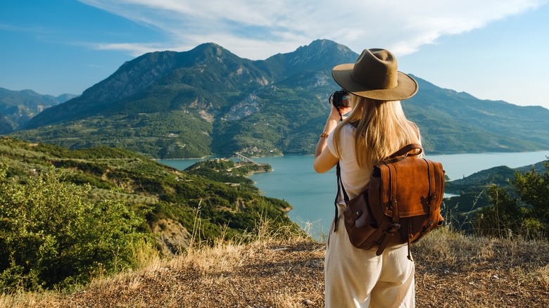 Woman photographing mountains