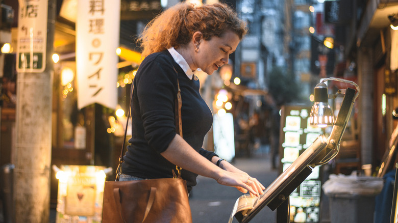 Woman looking at restaurant menu
