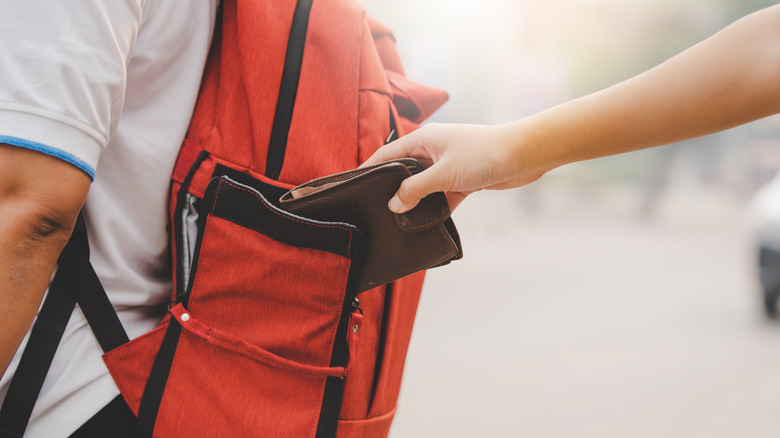 Pickpocket stealing a wallet