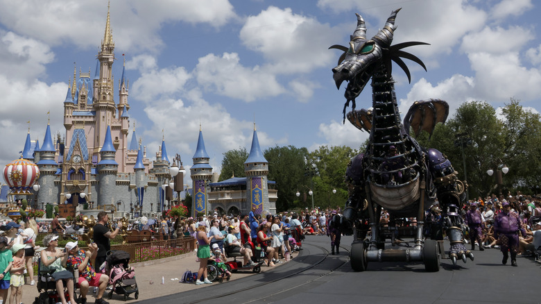 The Cinderella Castle parade dragon dwarfing spectators.