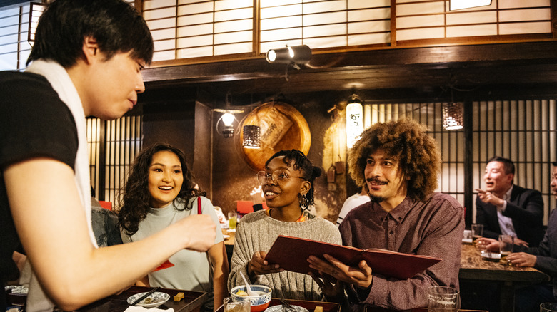 Foreign customers ordering Japanese restaurant