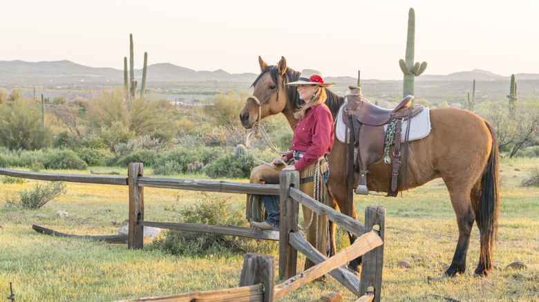 Cowgirl with horse on ranch