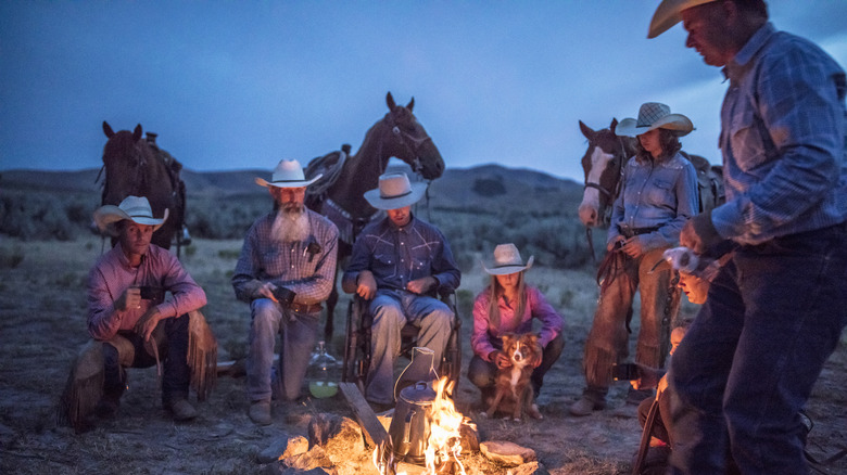 Group of ranchers by an open fire