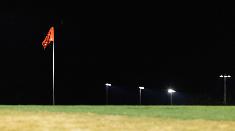 A well-lit golf green at night