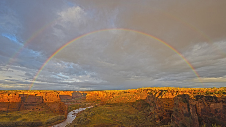 A double rainbow over deep red canyons
