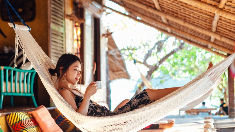 A woman relaxing in a tropical hammock