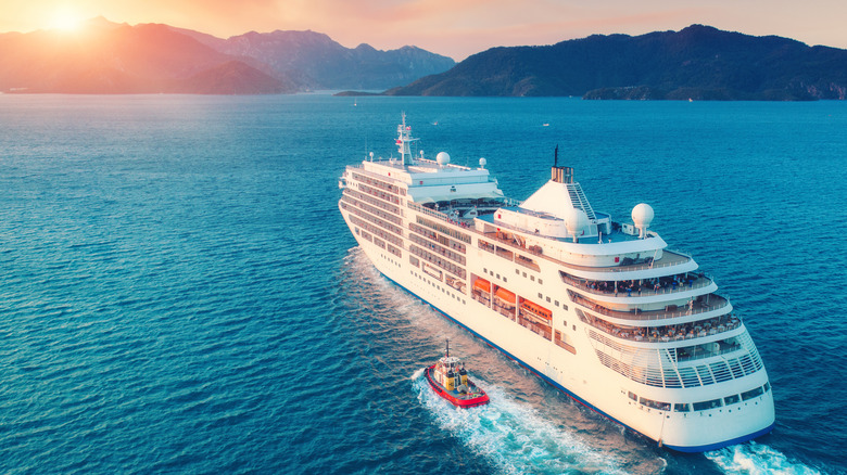 Cruise ship sailing at sunset