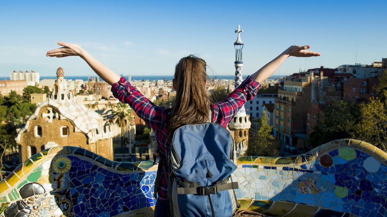 Female tourist overlooking the Parc Guell in Barcelona, Spain
