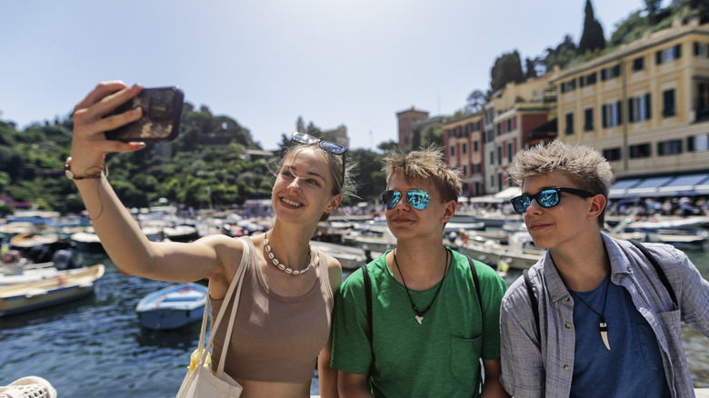 Tourists taking selfie in Portofino, Italy