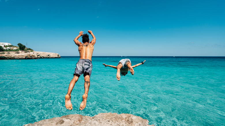 People jumping into the sea