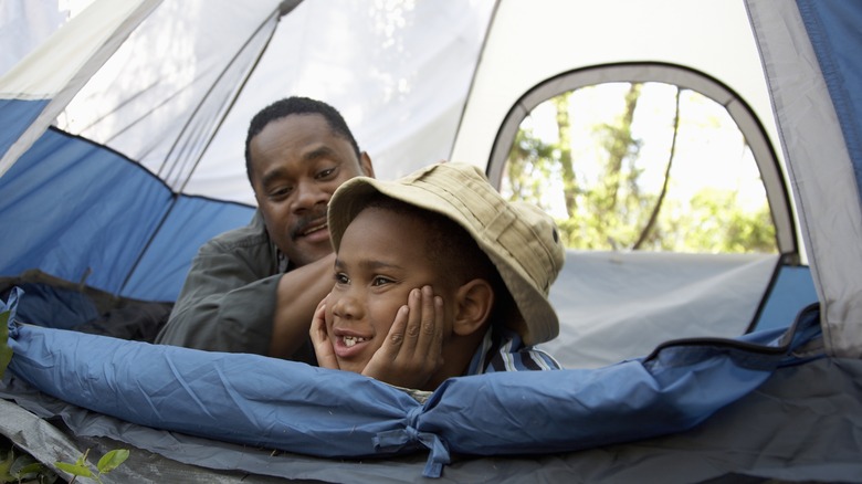 adult and child in tent
