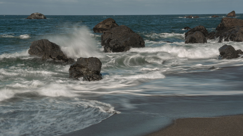 Surf hitting the rocks on a California beach.