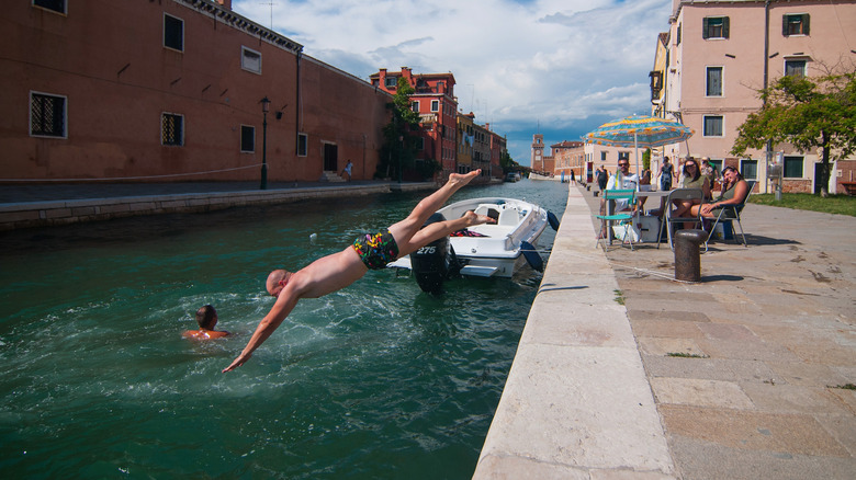 A man diving into a canal