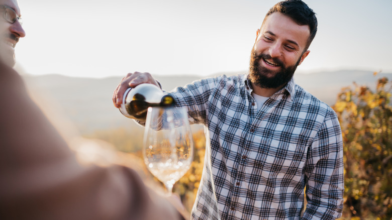 man pouring wine